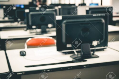 Defocused student study computer classroom for background.